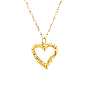 Close-up detail of textured hollow heart pendant in 18k gold plated stainless steel