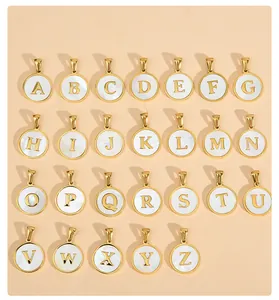 Detail view of 26 gold stainless steel alphabet pendants with white mother of pearl inlay.