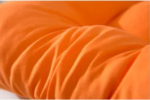 Detailed macro view showing the soft orange brushed fabric texture of the seat cushion