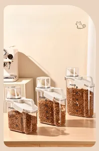 Detail view of 3 sizes of airtight pet food containers with measuring cups and handles.
