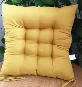 Close-up of yellow tufted chair cushion with ties for home or office
