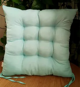 Detailed view of light blue brushed chair cushion with tufted design and ties