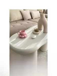 Detail view of pink flower-shaped coffee cup and saucer set on table