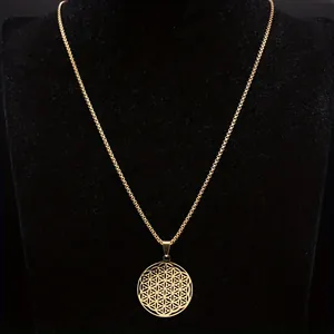 Macro view of gold stainless steel Flower of Life pendant on black velvet display