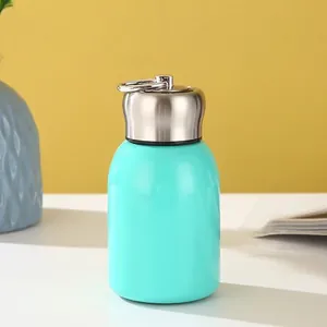 Mini insulated stainless steel bottle with carrying ring and mint green finish