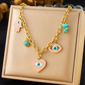 Detailed view of a gold-plated stainless steel necklace with Hamsa and Evil Eye charms