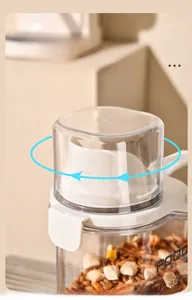 Close-up of transparent pet food container with measuring cup lid and airtight seal.