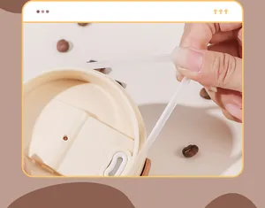 Detailed view of the elastic silicone handle on a modern stainless steel coffee cup lid.