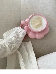 Elegant pink flower-shaped ceramic coffee cup set with latte art in aesthetic setting