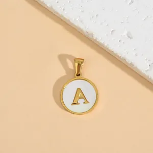 Minimalist stainless steel round pendant necklace with golden initial A on white background