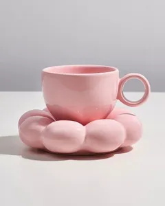 Detailed view of a pink ceramic flower-shaped saucer and matching coffee cup
