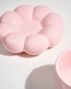 Close-up of a pink flower-shaped ceramic plate with a smooth glossy finish
