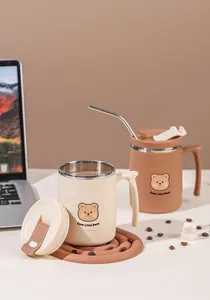 Detailed view of two insulated stainless steel bear pattern coffee mugs with lids and straw