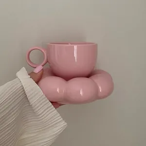 Elegant pink ceramic coffee cup set with creative flower-shaped saucer in minimalist style