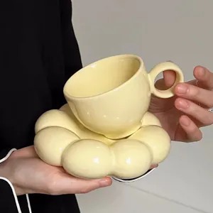 Elegant light yellow ceramic coffee cup set with creative flower shaped saucer