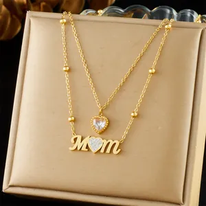 Detailed view of elegant gold-plated layered necklace with heart and MOM pendant