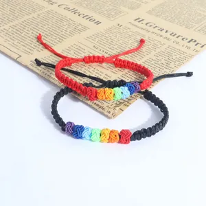 Close-up of rainbow knot braided bracelets on vintage newspaper background