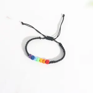 Detailed view of handmade rainbow knot woven bracelet with adjustable black cord