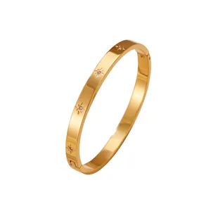 Luxury 18K gold plated titanium steel bangle with star engravings and clear stones