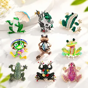 Collection of varied frog brooches featuring crystals and colorful enamel finishes
