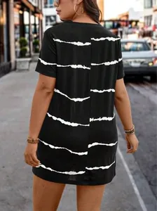 Detailed back view of a black short-sleeved plus size dress with white jagged stripes