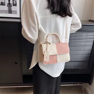 Elegant pink and beige color-block crossbody handbag with top handle and flap closure