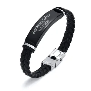 Detail of personalized engraving on black braided leather bracelet with steel clasp