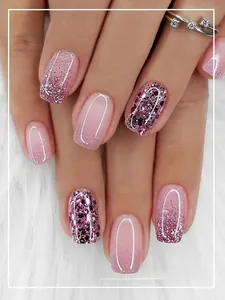 Detail view of pink glitter gradient press-on nails in short square shape for elegant look.