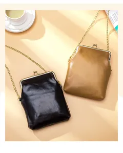 Detail view of retro leather phone bags with gold chain straps and kiss-lock closure