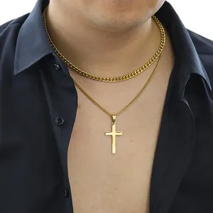 Detail view of double-layered gold Cuban chain with polished cross pendant