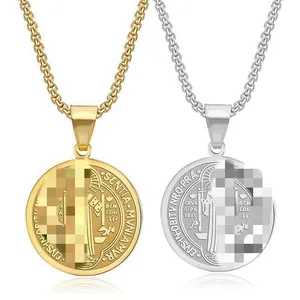 Detail of stainless steel Saint Benedict medal pendants in gold and silver finish