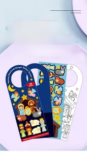 Macro view of children's DIY nativity scene door hanger sticker sheets and accessories.