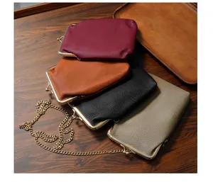 Detail view of colorful genuine leather kiss-lock phone bags with golden metal chain straps