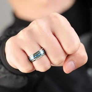 Close-up detail of stainless steel ring with two rows of blue abalone shell inlays