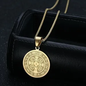 Detailed view of the St. Benedict medal pendant in gold-plated stainless steel material
