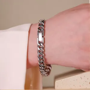 Close-up of a silver stainless steel Cuban link bracelet with a secure fold-over clasp