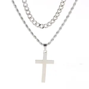 Detail view of double-layered stainless steel necklace with cross pendant and rope chain
