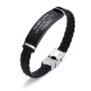 Detailed view of braided leather bracelet with engraved black stainless steel ID plate.