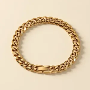 Detailed view of a gold-toned titanium steel Cuban link bracelet with a jewelry clasp