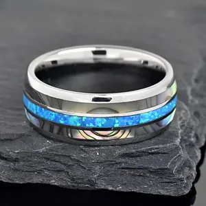 Silver stainless steel ring with blue crushed opal and iridescent abalone shell inlays.