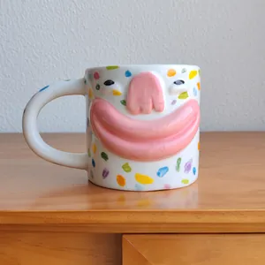 Detailed macro view of a quirky creative 3D face ceramic mug with colorful splatter dots