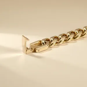 Macro view of premium gold stainless steel Cuban link bracelet featuring a secure jewelry clasp