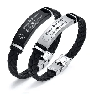 Close-up of engraved braided leather couple bracelets with stainless steel plates