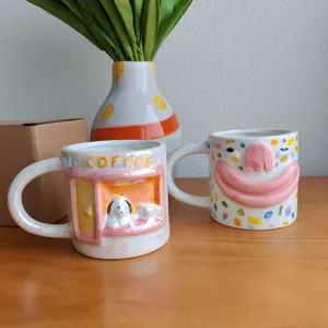Detailed view of two creative 3D ceramic mugs with funny face and dog designs