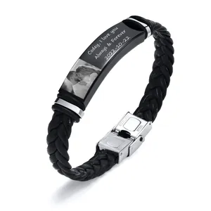 Detail view of a braided leather bracelet with personalized engraved stainless steel plate