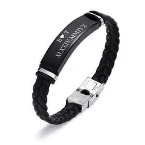 Detail of braided leather bracelet with engraved black stainless steel plate