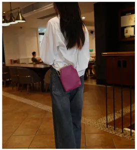 Purple genuine leather phone bag with gold chain strap shown on a model