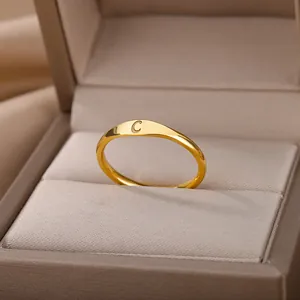 Detailed macro view of a minimalist gold ring featuring a finely engraved letter C design