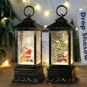 Two vintage Christmas snow globe lanterns with warm LED lights and festive Santa scenes.