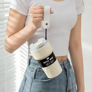 Detail view of the cream portable 304 stainless steel coffee mug with a handle strap.